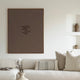 modern interior living room with a framed canvas wall art print in chocolate brown which reads "remember when you wanted what you currently have"