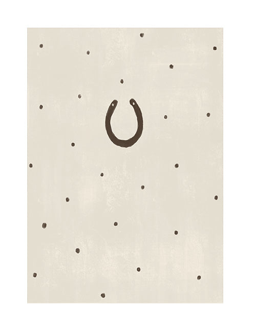 nursery wall art print, a horseshoe charm drawn over a beige background with polkadots