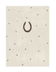 nursery wall art print, a horseshoe charm drawn over a beige background with polkadots